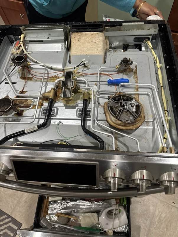 Appliance repair technician testing a dryer thermal fuse